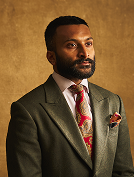 Man in a suit with a patterned tie and pocket square