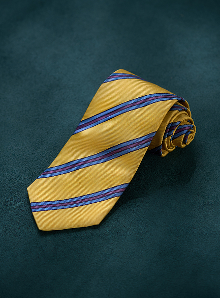 Yellow striped tie on a dark green background