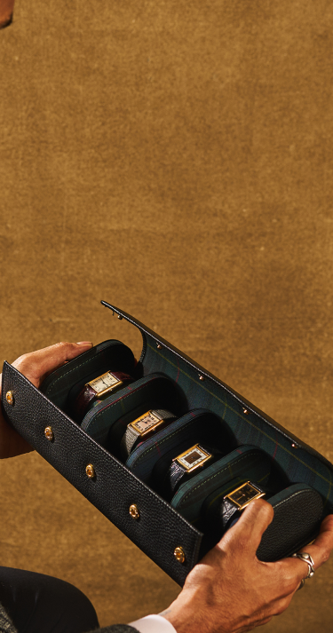 Black jewelry box with gold watches.