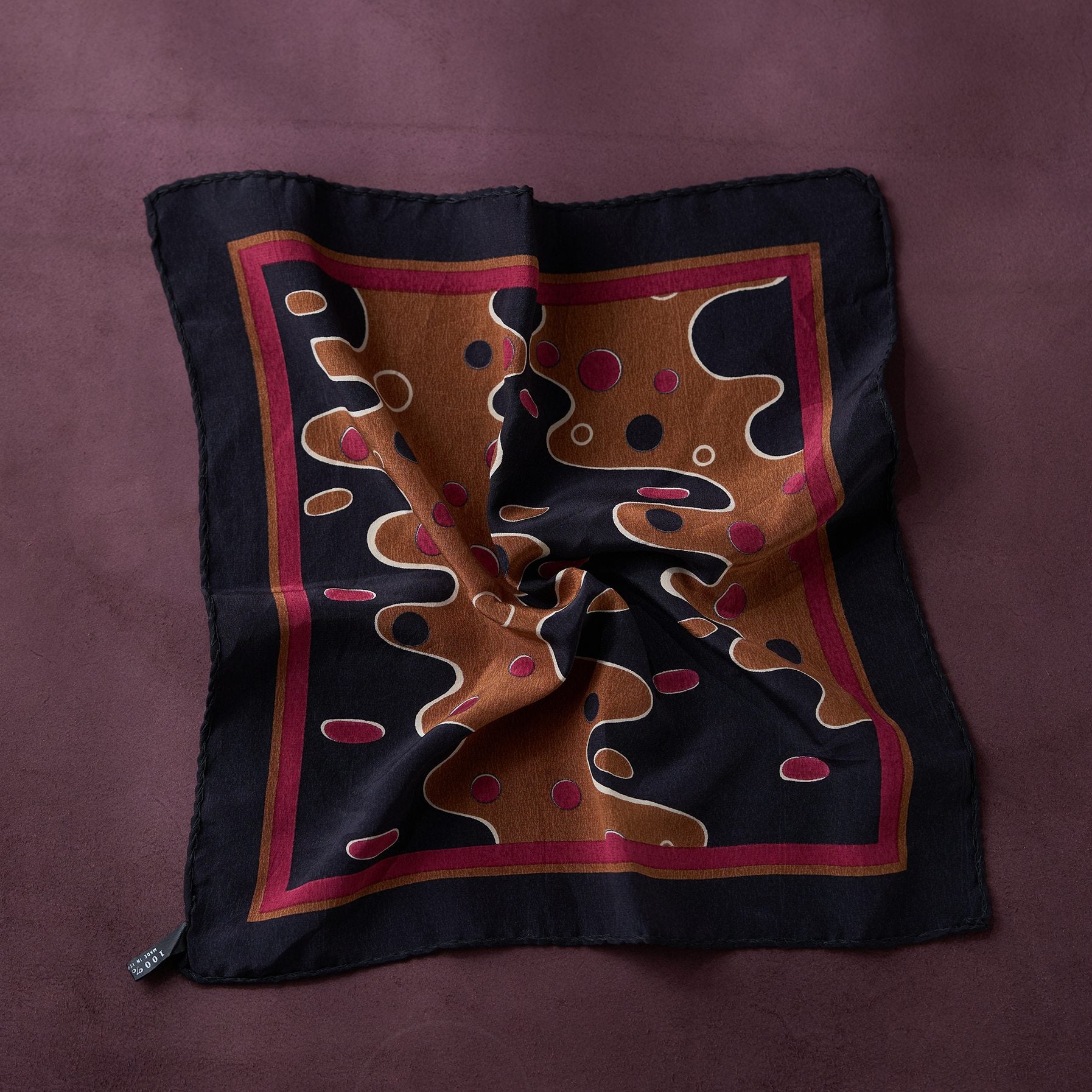 Decorative pillow with abstract pattern on a purple background