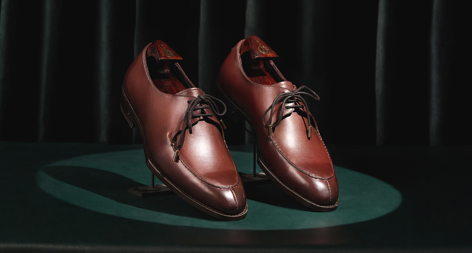 Pair of brown dress shoes on a dark background